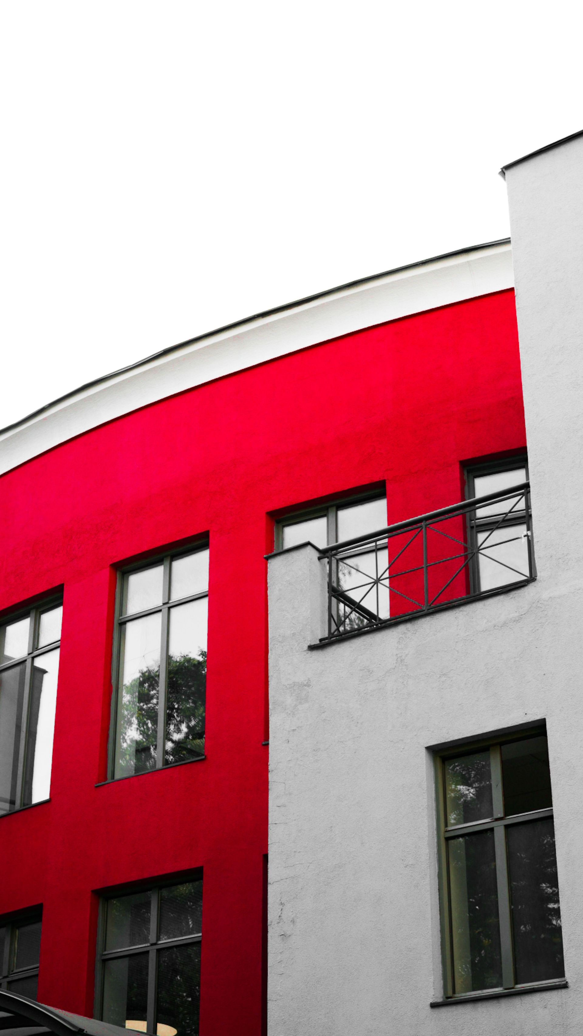 Colorful modern architecture featuring striking red and white design with large windows.